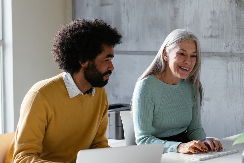 accountant and client sitting at computer smiling